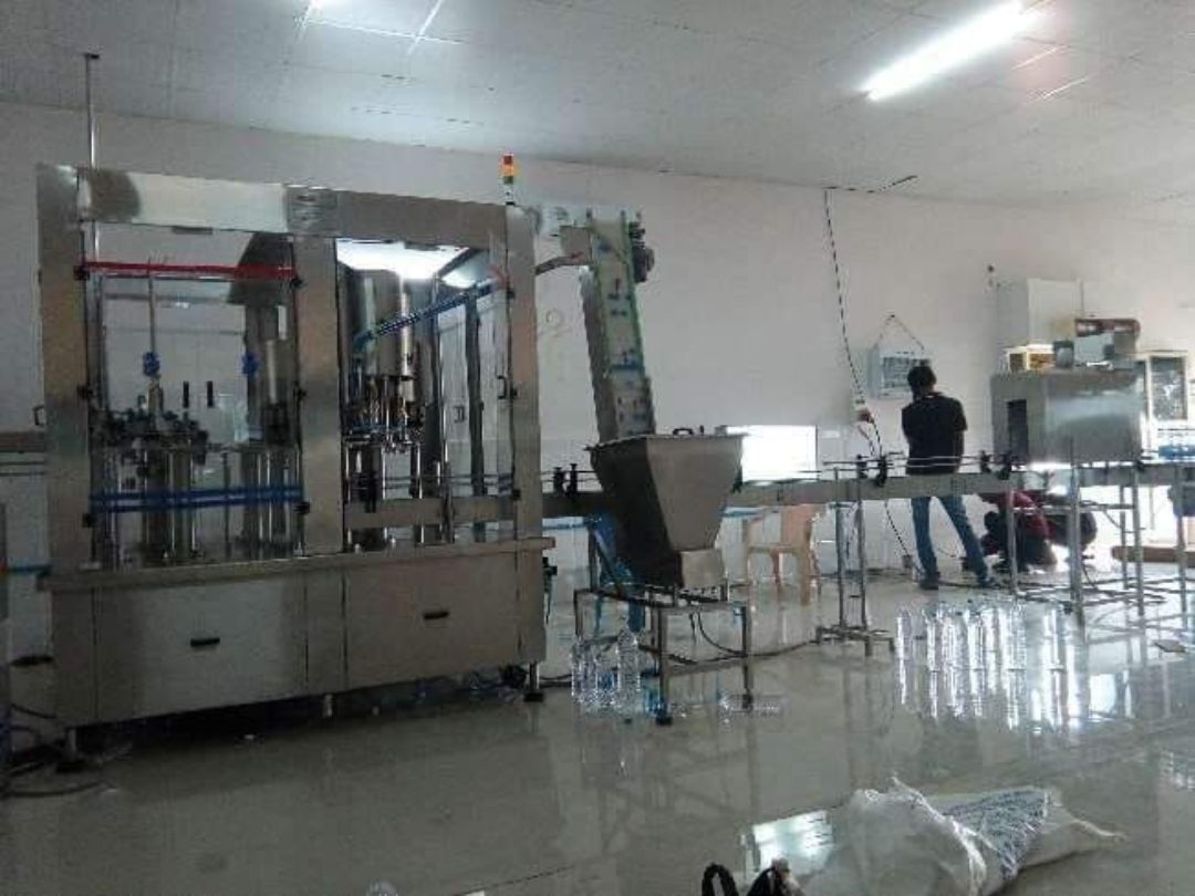 Packaged drinking water bottling line: rinsing-filling-capping machine and conveyor – PureFlux Engineering, Chennai
